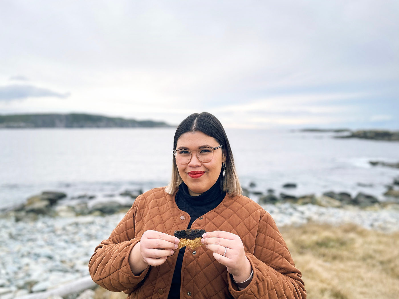 Stephanie Lipp, co-founder and CEO of MycoFutures, holding a piece of mycelium material on the coast
